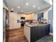 Kitchen featuring white cabinets, stainless steel appliances, granite countertops, and hardwood floors at 1608 20Th W Ave, Palmetto, FL 34221