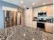 Spacious kitchen with stainless steel appliances, granite countertops, and ample storage in neutral cabinetry at 1608 20Th W Ave, Palmetto, FL 34221
