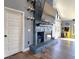 Cozy living room featuring a stone fireplace, arcade game, and ample natural light at 1608 20Th W Ave, Palmetto, FL 34221