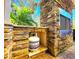 Outdoor fireplace features a stone surround with built-in shelving for accessories at 1608 20Th W Ave, Palmetto, FL 34221