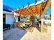 Outdoor kitchen and dining area featuring a fireplace and stainless steel appliances at 1608 20Th W Ave, Palmetto, FL 34221