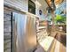 Outdoor bar area with stainless steel fridge, stone accent surround, and Corona beer tap at 1608 20Th W Ave, Palmetto, FL 34221