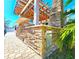 An outdoor kitchen features stone accents, stainless steel features, and a wooden pergola at 1608 20Th W Ave, Palmetto, FL 34221