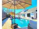 Stunning pool area with large umbrella, lounge chairs, and view of the beautiful home at 1608 20Th W Ave, Palmetto, FL 34221