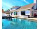 Beautiful backyard with an in-ground pool and an expansive white home with large windows at 1608 20Th W Ave, Palmetto, FL 34221