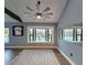 Relaxing sitting area with a large window view of the pool area and a unique ceiling fan at 1608 20Th W Ave, Palmetto, FL 34221