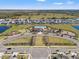 An aerial view of the community with a pool, playground, common areas, and surrounding neighborhood homes at 16632 Sunburst Lake St, Wimauma, FL 33598