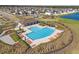 Aerial view of the community pool and amenities, featuring ample lounge seating and lush landscaping at 16632 Sunburst Lake St, Wimauma, FL 33598