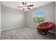 Comfortable bedroom featuring a cozy papasan chair and a window with natural light at 16632 Sunburst Lake St, Wimauma, FL 33598