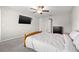 Bright bedroom features carpet floors, ceiling fan, and large bed with white linens at 16632 Sunburst Lake St, Wimauma, FL 33598