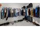 Walk-in closet with ample storage, featuring hanging racks and shoe storage, great for organizing your wardrobe at 16632 Sunburst Lake St, Wimauma, FL 33598