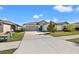Charming single-story home with a well-manicured lawn and a two-car garage and mature landscaping at 16632 Sunburst Lake St, Wimauma, FL 33598
