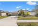 Charming single-story home with a well-manicured lawn and a two-car garage in a suburban neighborhood at 16632 Sunburst Lake St, Wimauma, FL 33598
