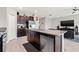 Open kitchen features granite countertops, stainless appliances, and island with sink and dishwasher at 16632 Sunburst Lake St, Wimauma, FL 33598