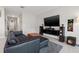 Comfortable living room with leather couch, large television and modern sound system at 16632 Sunburst Lake St, Wimauma, FL 33598