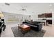 Open-concept living space with tile floors, a large sofa and access to the kitchen at 16632 Sunburst Lake St, Wimauma, FL 33598