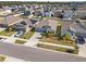 Street view of the homes featuring well-maintained landscaping, driveways, and a glimpse of the neighborhood's charm at 16632 Sunburst Lake St, Wimauma, FL 33598