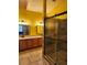A well-lit bathroom featuring a glass shower and double vanity at 17430 Spring Valley Rd, Dade City, FL 33523