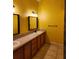 Bathroom featuring dual sinks and vanity with bright yellow walls at 17430 Spring Valley Rd, Dade City, FL 33523