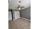 Neutral bedroom features tile floors, ceiling fan and closet with white double doors at 17430 Spring Valley Rd, Dade City, FL 33523