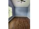 Bright bedroom featuring hardwood floors, a window and soft paint at 17430 Spring Valley Rd, Dade City, FL 33523