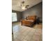 A bedroom with neutral tile floors and furniture at 17430 Spring Valley Rd, Dade City, FL 33523