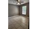 Neutral bedroom with tile flooring and a window offering natural light at 17430 Spring Valley Rd, Dade City, FL 33523