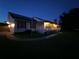 Dusk view of home shows an expansive front yard and a welcoming porch at 17430 Spring Valley Rd, Dade City, FL 33523