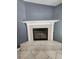 Close-up of a gas fireplace with a white mantle and tile surround at 17430 Spring Valley Rd, Dade City, FL 33523