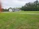 Charming single-story home with a covered porch and sprawling green lawn at 17430 Spring Valley Rd, Dade City, FL 33523