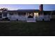 Inviting two-story home with a charming front porch and well-manicured lawn at 17430 Spring Valley Rd, Dade City, FL 33523