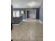 Open living space with tiled floors and views into the kitchen and beyond at 17430 Spring Valley Rd, Dade City, FL 33523