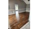 Bright living room features hardwood flooring and an open doorway at 17430 Spring Valley Rd, Dade City, FL 33523