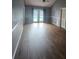 A spacious living room with hardwood floors and a view of the pool at 17430 Spring Valley Rd, Dade City, FL 33523