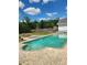Backyard oasis features a spacious pool and lush green landscaping at 17430 Spring Valley Rd, Dade City, FL 33523
