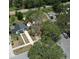 An aerial view of a well-maintained home with a spacious yard and mature trees in a quiet neighborhood at 1762 Fulton Ave, Clearwater, FL 33755