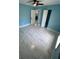 Bedroom featuring tile flooring, two windows for natural light, ceiling fan, and blue walls at 1762 Fulton Ave, Clearwater, FL 33755