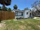 Well-maintained home exterior with fresh paint, manicured lawn, and charming curb appeal at 1762 Fulton Ave, Clearwater, FL 33755
