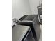 Modern washer and dryer set with gray finishes, alongside a water heater at 1762 Fulton Ave, Clearwater, FL 33755