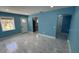 Bright living room featuring tile floors, fresh blue paint, and a large window for natural light at 1762 Fulton Ave, Clearwater, FL 33755