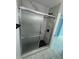 Modern bathroom shower featuring marble tile, black hardware, and glass enclosure at 1762 Fulton Ave, Clearwater, FL 33755