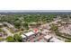 Aerial view of the property in a neighborhood setting with tree coverage and buildings at 1799 N Highland Ave # 3, Clearwater, FL 33755