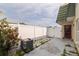 View of backyard with concrete patio, privacy fence, air conditioning unit, and some greenery at 1799 N Highland Ave # 3, Clearwater, FL 33755