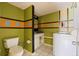 Full bathroom features a standard toilet, tile floor and a washing machine at 1799 N Highland Ave # 3, Clearwater, FL 33755