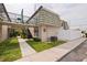 Inviting condo exterior featuring manicured lawn, white picket fence, black iron stairway, and assigned parking at 1799 N Highland Ave # 3, Clearwater, FL 33755