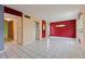 Bright living room showcasing neutral walls, tile floor, and multiple closets at 1799 N Highland Ave # 3, Clearwater, FL 33755