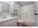 A well-lit bathroom with a combination shower and tub features white cabinets and modern fixtures at 1828 Foxhunt Dr # A, Sun City Center, FL 33573