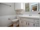 Bathroom featuring neutral paint, white vanity, sink, toilet, and hardware at 1828 Foxhunt Dr # A, Sun City Center, FL 33573
