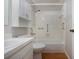 Bathroom featuring white tiles, a bathtub with grab bars, and a sink and vanity combo at 1828 Foxhunt Dr # A, Sun City Center, FL 33573