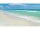 Beautiful beach view with clear, turquoise water and white sand shoreline at 1828 Foxhunt Dr # A, Sun City Center, FL 33573